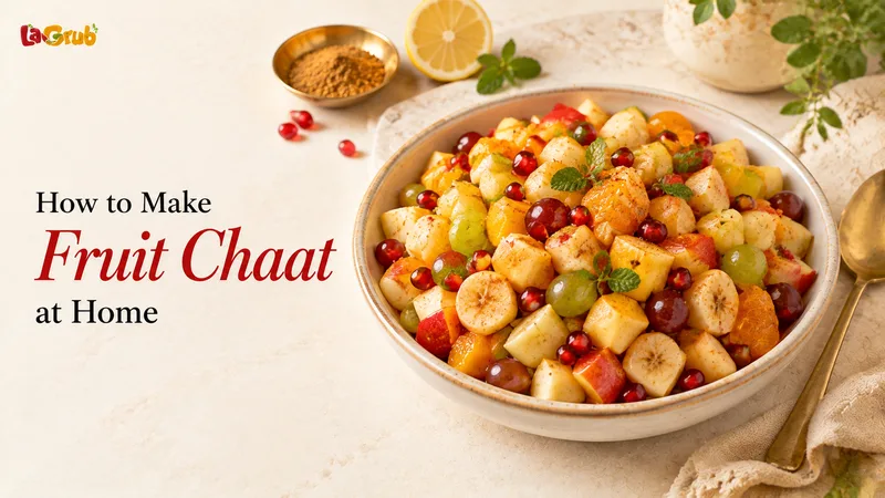 A colorful bowl of Pakistani fruit chaat with apples, bananas, grapes, oranges, pomegranate, and chaat masala